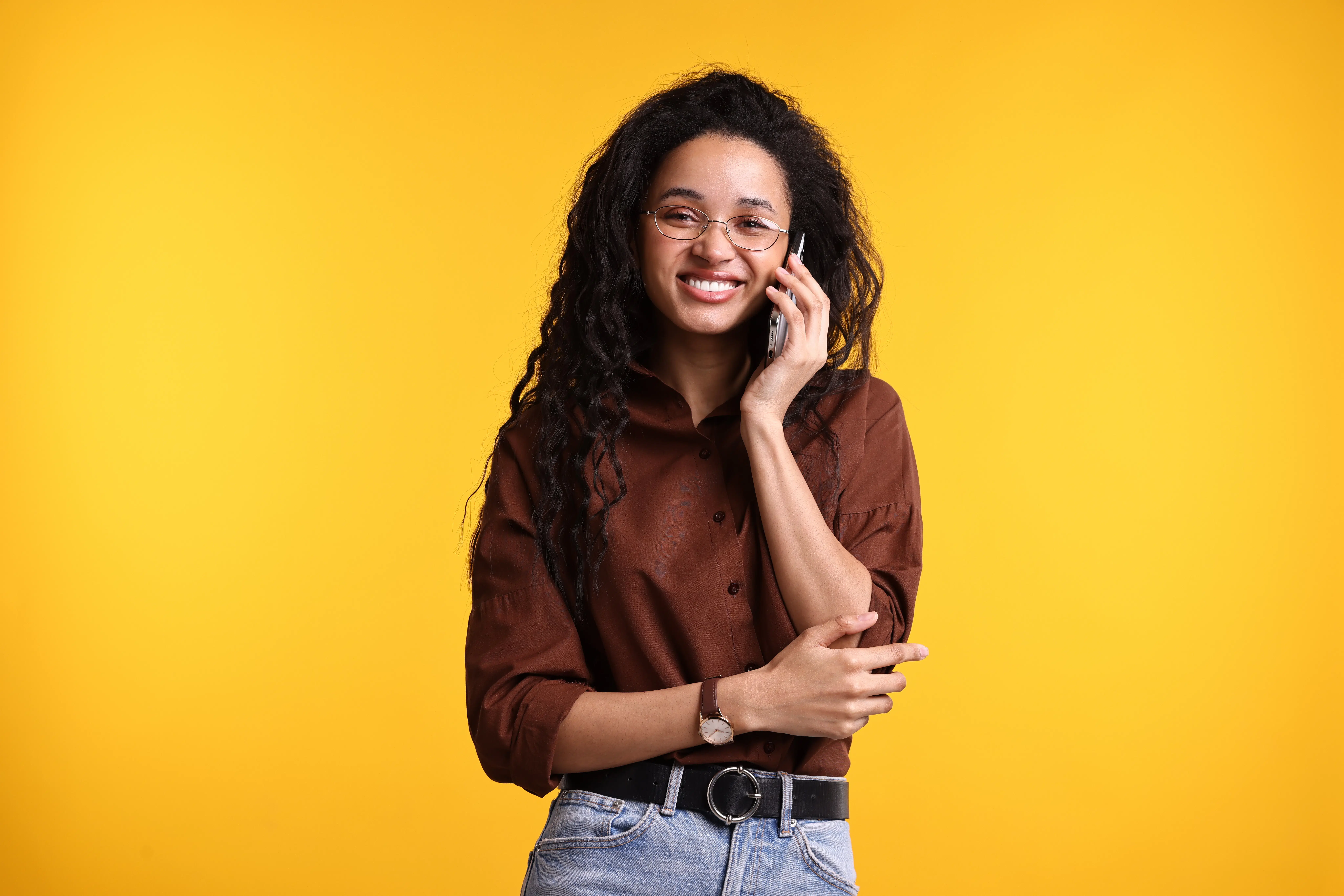A smiling woman talking on her phone